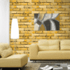 RUSTIC YELLOW BRICK WALLPAPER WITH MODERN ARTWORK FOR A CONTEMPORARY INDUSTRIAL LIVING SPACE WALLPAPER