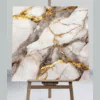 BOLD VEINS OF SMOKY GREY AND RICH, TEXTURED GOLD DRAMATICALLY FRACTURE A PRISTINE WHITE MARBLE CANVAS UV MARBLE SHEET